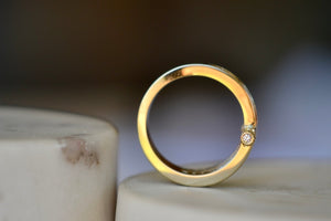 Magna ring by Retrouvai. View of diamond on pin.
